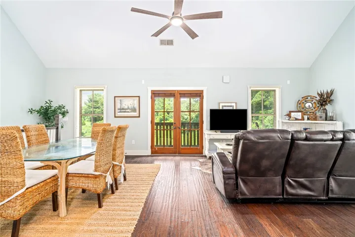 Hardwood floors and soaring ceilings define this inviting living and dining space.