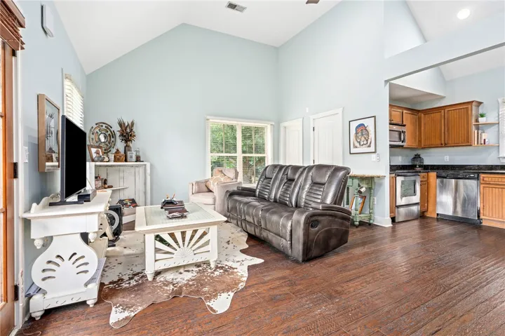 A great room with soaring vaulted ceilings and richly stained hardwood floors.