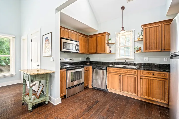 Vast vaulted ceilings complement rich hardwood floors and sleek stainless steel appliances.