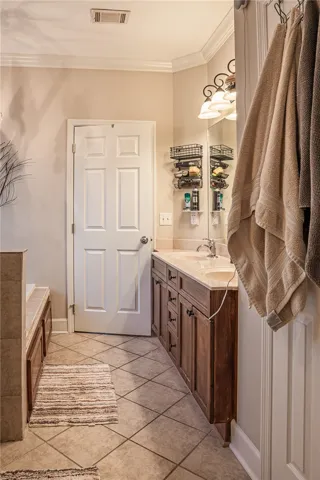 Dual vanity with ample storage and a deep soaking tub complete this well-appointed bath.