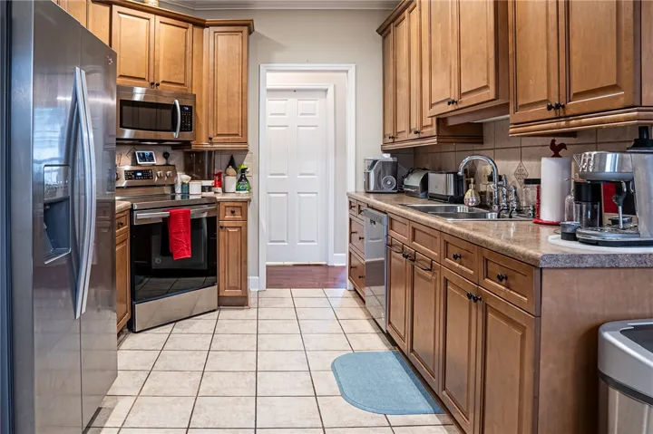 Well-appointed kitchen featuring light wood cabinetry, ample counter space, and stainless steel appliances for daily living.