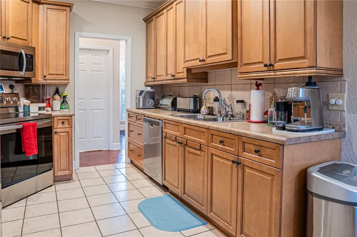 A well-appointed kitchen features ample cabinetry and integrated appliances, providing both function and classic charm.