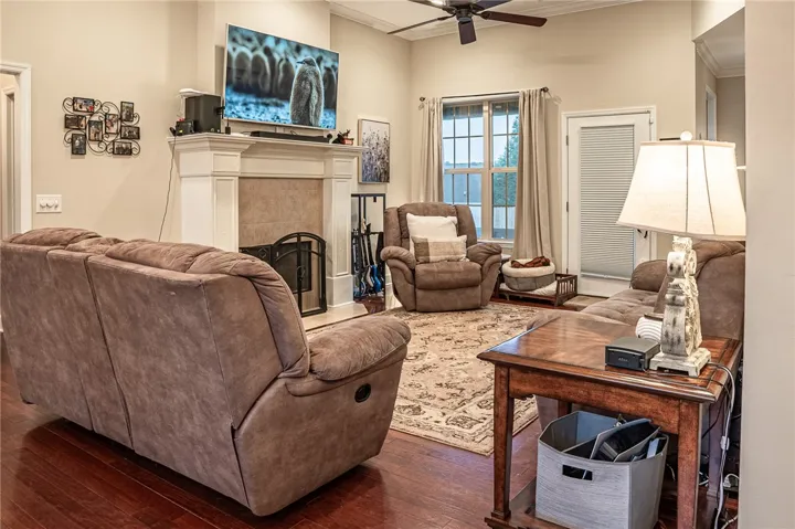 Hardwood floors and a welcoming fireplace create a cozy living space for relaxation.