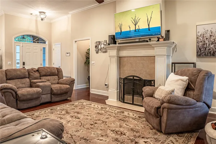Warm hardwood floors and a classically styled fireplace define this inviting living space.