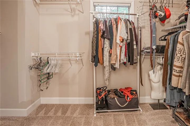 Functional closet space offers wire shelving and carpet flooring for practical storage solutions.