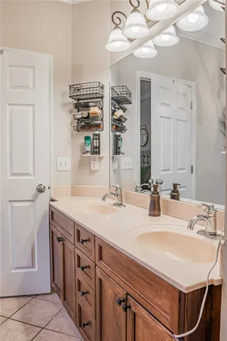 Double vanity with ample storage and a broad mirror anchors this bright bathroom space.