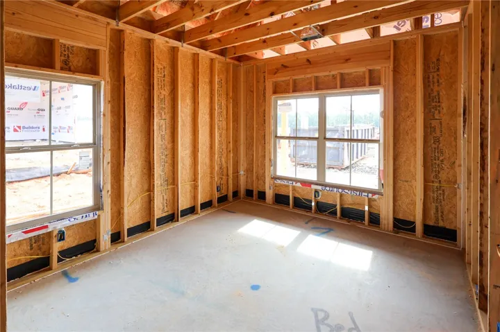 Raw framing and concrete flooring outline the bones of this upcoming residential space.