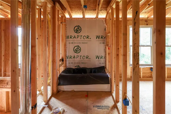 Exposed wood framing reveals the structural layout and early installation of a bathroom tub.