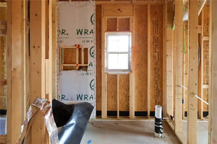 Exposed wood framing and subflooring outline this future room currently under construction.