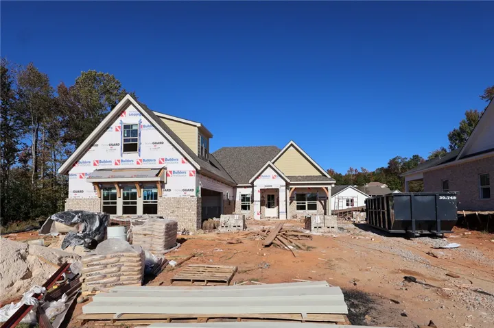 An ongoing construction project showcases a spacious multi-level design under a clear blue sky.