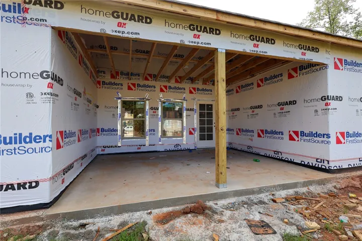 Progress continues on this new home construction featuring a covered concrete back porch.