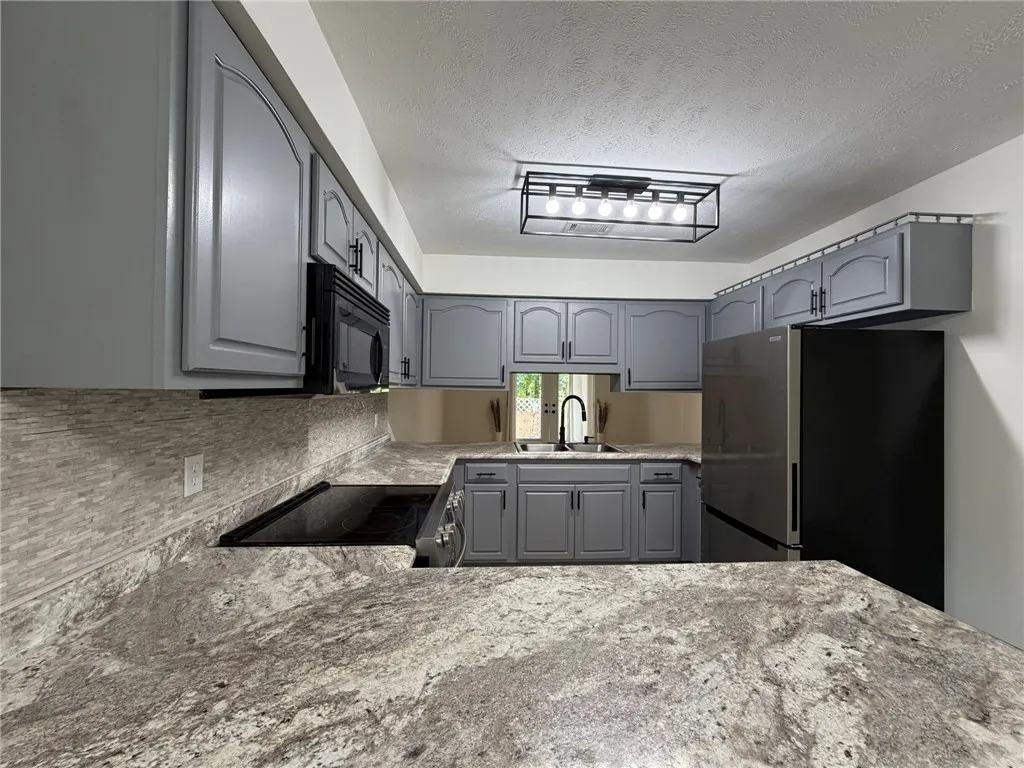 A well-appointed kitchen features ample counter space and integrated appliances for modern living.