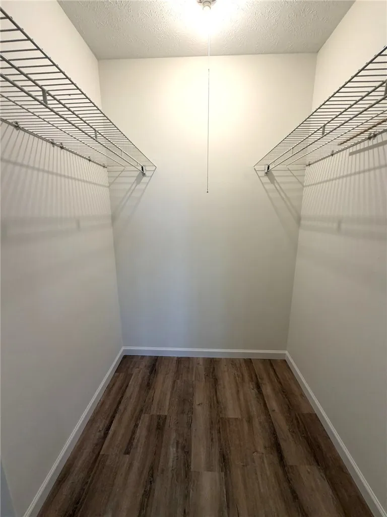 Ample shelving in this well-organized large closet provides essential storage solutions.