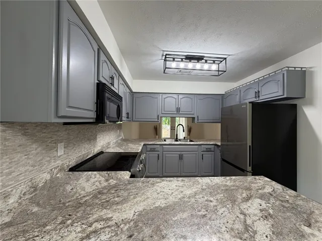 A well-appointed kitchen features ample counter space and integrated appliances for modern living.
