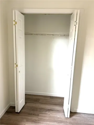 An organized closet offers optimal storage with a convenient hanging rod.