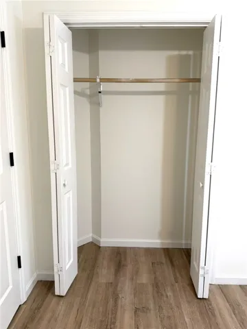An essential and versatile storage solution, this closet features durable wood flooring.