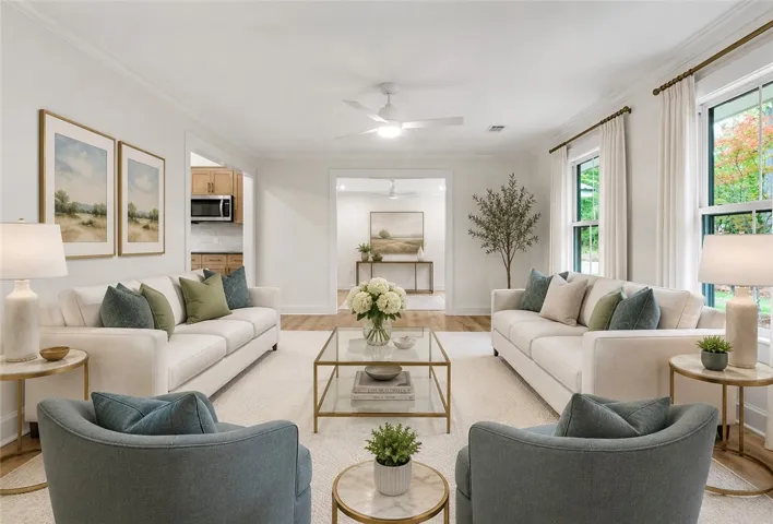 Natural light floods this inviting living space, connecting seamlessly to the kitchen and beyond.