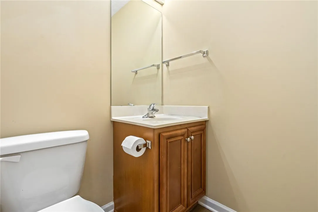 A well-appointed powder room features a classic vanity and toilet.