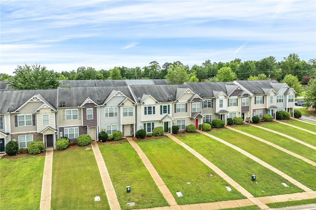 A community of attractive townhomes with tidy green lawns and mature landscaping.