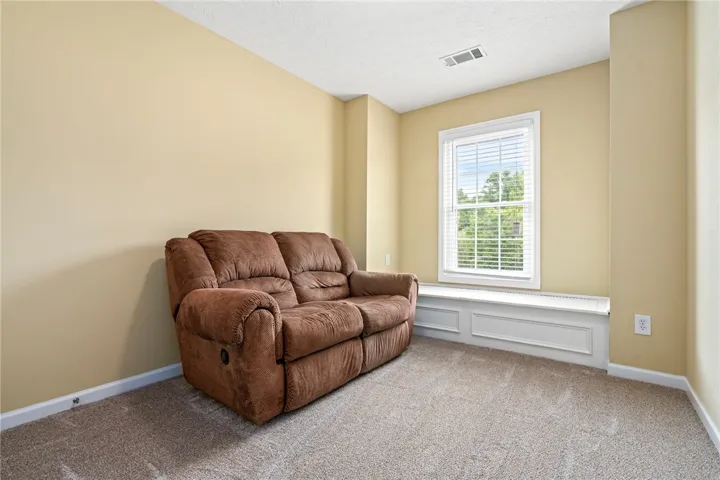 A window seat offers a pleasant spot to relax in this comfortable living space.