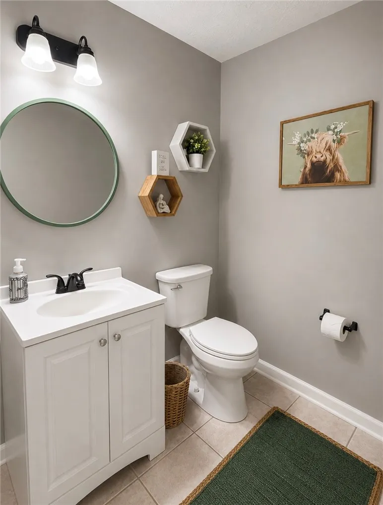 A well-appointed lavatory with a pristine vanity and tile flooring.
