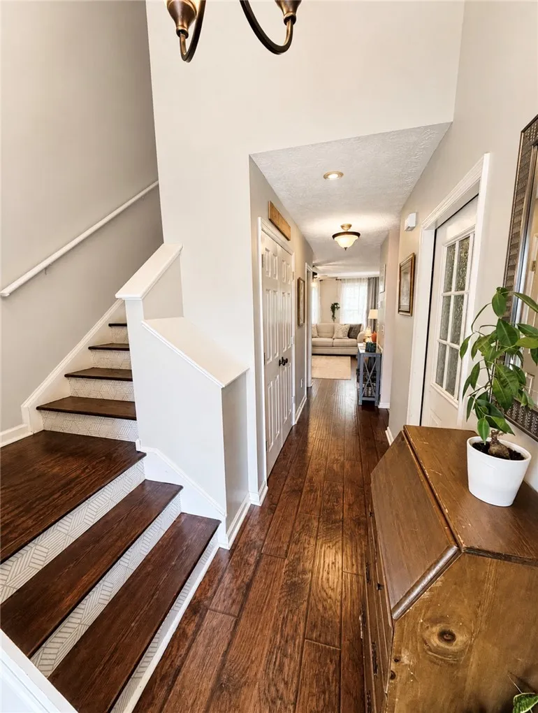 Rich hardwood floors welcome you into this inviting home, leading to a gracefully ascending staircase.