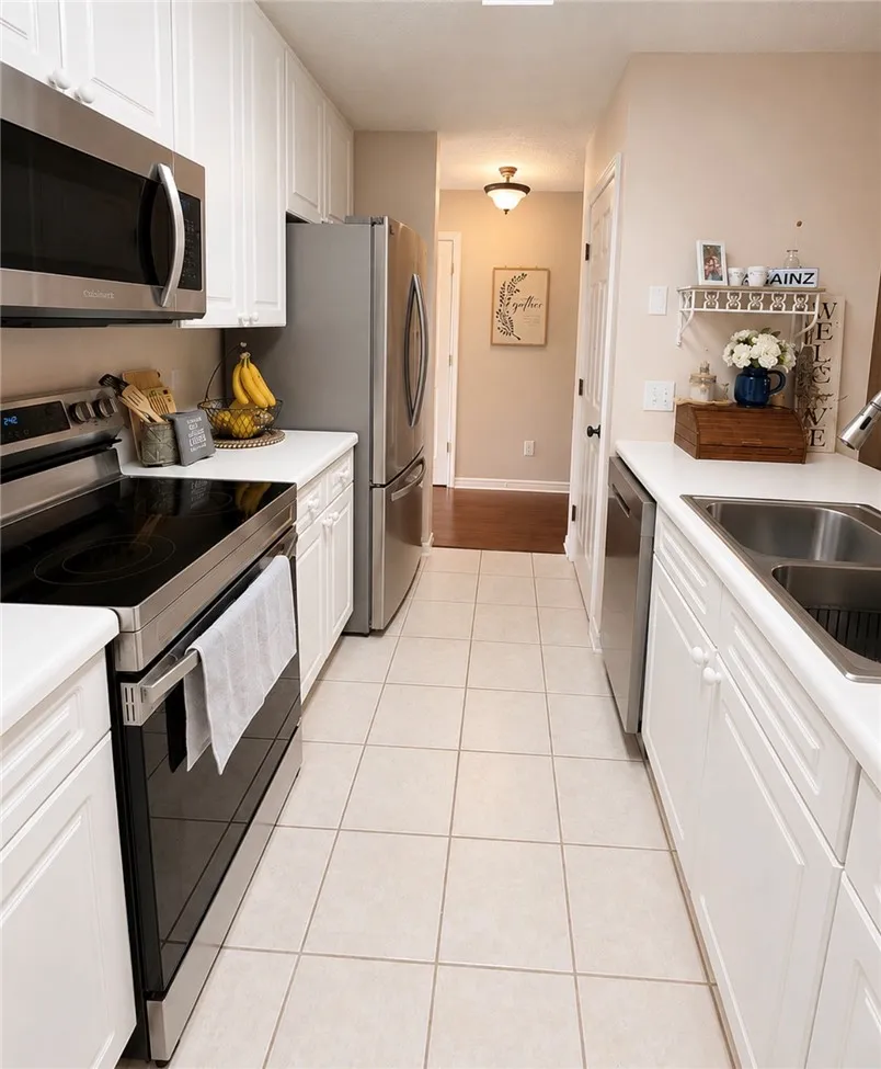A well-appointed kitchen features stainless steel appliances and ample counter space for culinary endeavors.