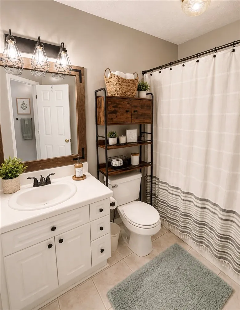 A well-appointed bathroom with a spacious vanity, framed mirror, and a convenient storage unit over the toilet.
