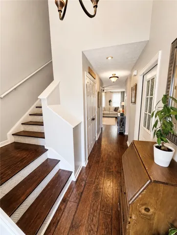Rich hardwood floors welcome you into this inviting home, leading to a gracefully ascending staircase.