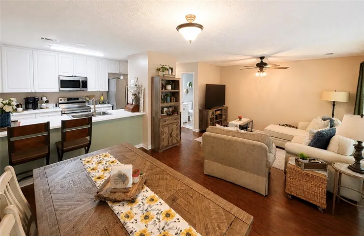 An inviting open-concept layout unites the kitchen, dining area, and living space, ideal for entertaining.
