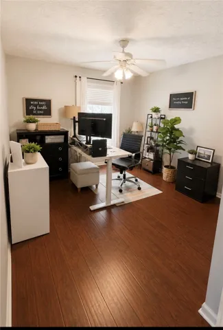 Work from home in comfort within this well-lit office, featuring rich hardwood floors and ample space.