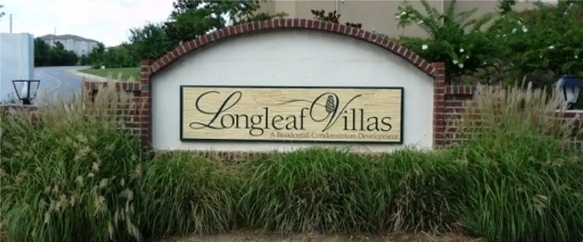 Elegant brick and stucco sign welcoming residents to the Longleaf Villas condominium development.