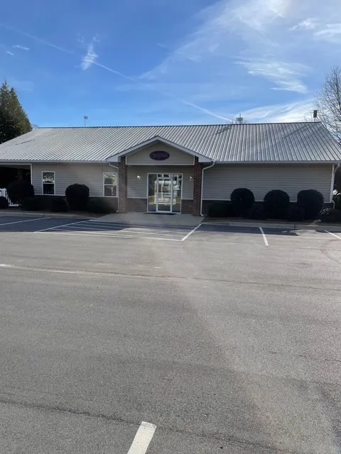 A commercial building with ample parking, presenting a functional and inviting presence.