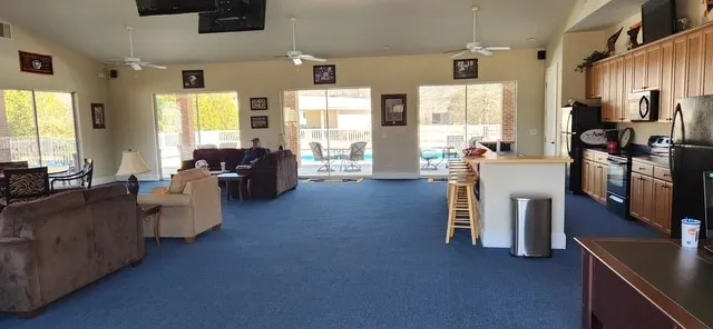 An inviting open-concept common area offers a full kitchen and spacious lounging, perfect for community gatherings.