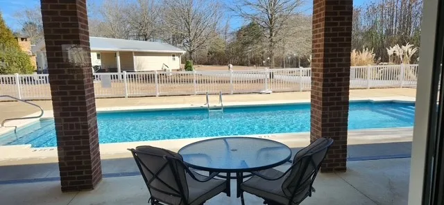Relax poolside on the private patio, offering direct access to the sparkling water.