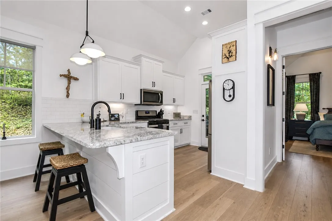 Bright white kitchen cabinets and countertops create an inviting atmosphere.
