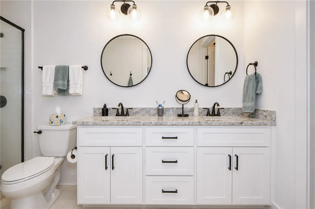 A well-appointed bath features a dual vanity with ample counter space and modern fixtures.