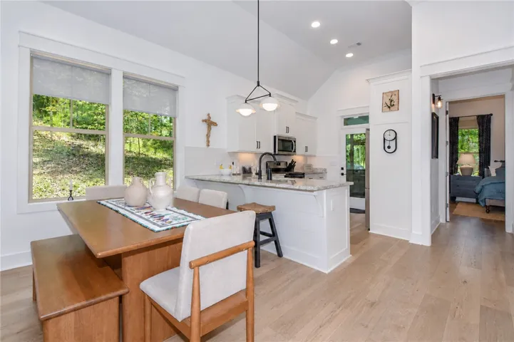 An open-concept design integrates the dining area with a modern kitchen, creating an inviting space.