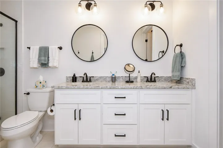A well-appointed bath features a dual vanity with ample counter space and modern fixtures.