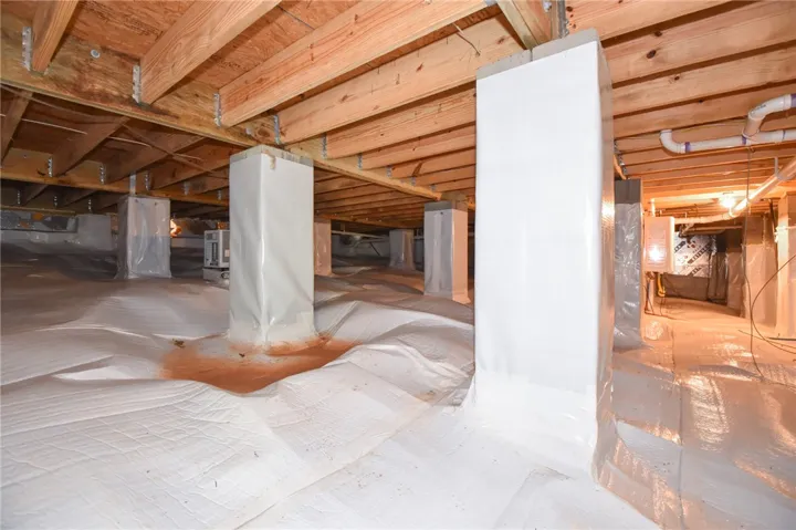 Clean and dry crawl space with wrapped piers provides a well-maintained foundation.