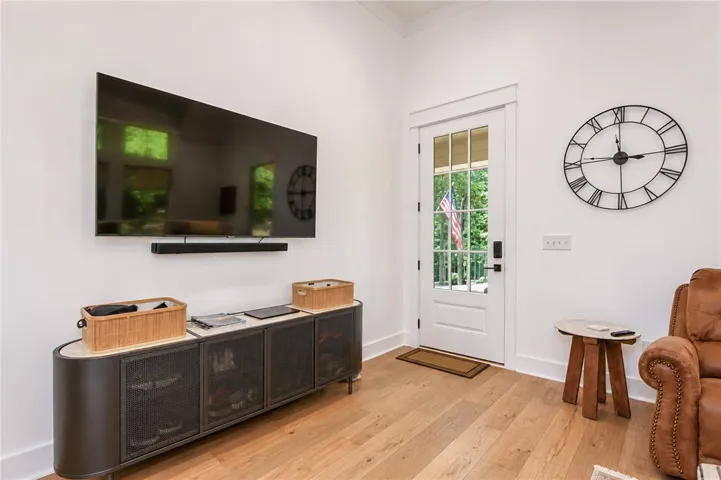 Bright hardwood floors and a white French door create a welcoming, open atmosphere.