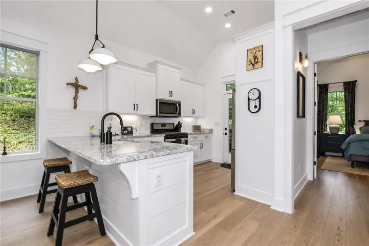 Bright white kitchen cabinets and countertops create an inviting atmosphere.