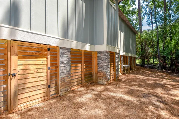 Board and batten siding meets rustic wood and stone accents, creating a charming foundation.