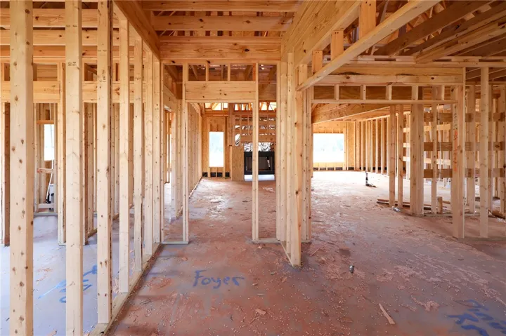 Exposed wood studs outline the spacious layout of this home currently under construction.