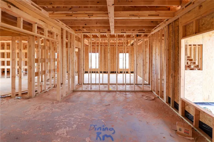 Exposed wood framing outlines the future dining room and living spaces during early construction.
