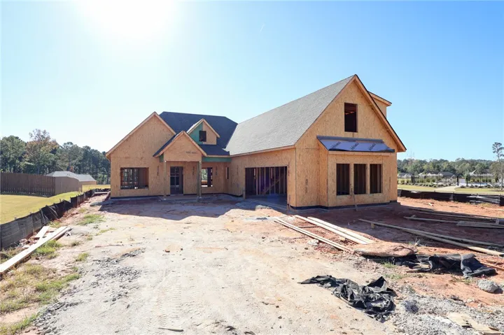 Progress continues on this custom residence, showcasing a striking architectural silhouette and premium framing.