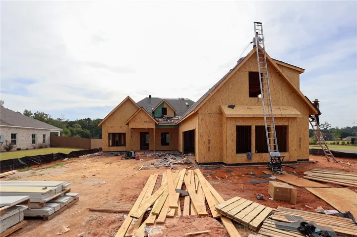 A new custom residence takes shape during active construction under a wide southern sky.