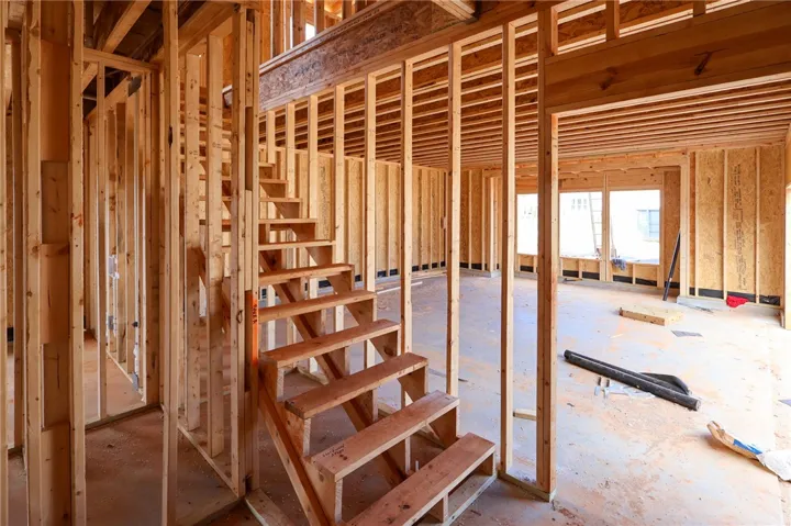 Sturdy wood framing and an open staircase define this home currently under construction.