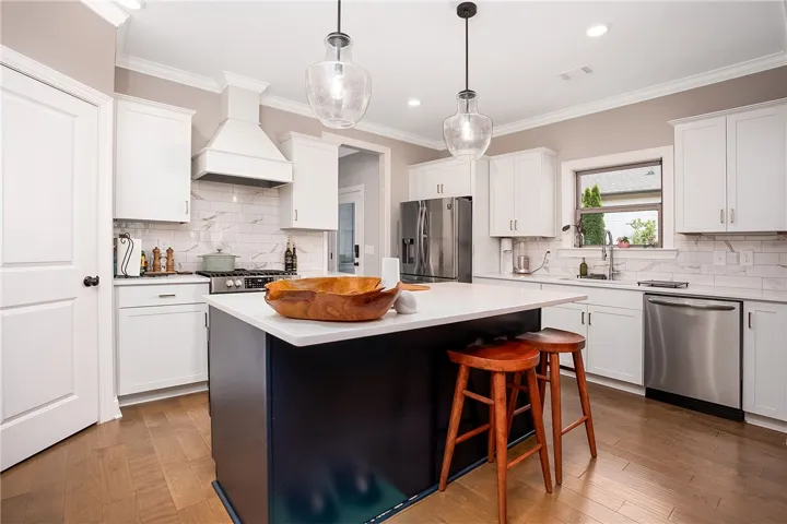 A well-appointed kitchen showcasing a central island and contemporary amenities, perfect for culinary endeavors.
