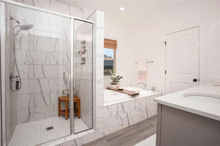 Luxurious bathroom retreat with a spacious walk-in shower and elegant built-in tub.